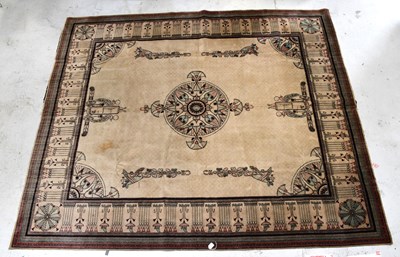 Lot 134 - A beige ground carpet with Egyptian decoration...