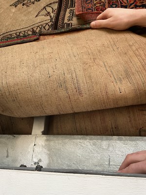 Lot 134 - A beige ground carpet with Egyptian decoration...