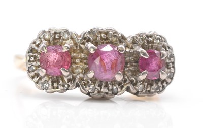Lot 462 - An 18ct yellow gold ruby and diamond triple...