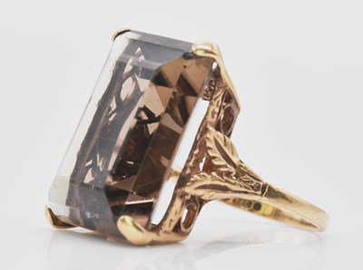 Lot 515 - A 9ct yellow gold smoky quartz dress ring,...