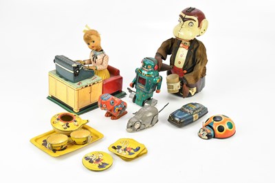 Lot 2118 - A collection of tinplate toys, to include a...