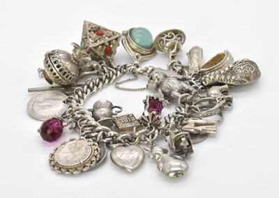 Lot 533 - A substantial silver charm bracelet set with a...