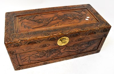 Lot 346 - A Chinese heavily carved camphor wood chest,...
