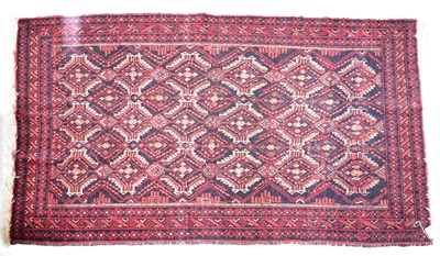 Lot 70 - A red ground woollen hand knotted rug, with...