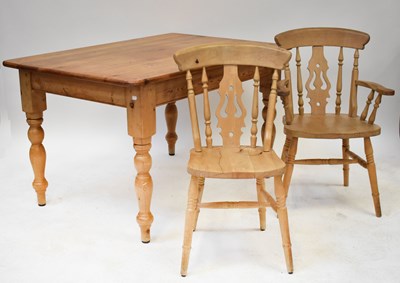 Lot 28 - A pine kitchen table with rounded rectangular...