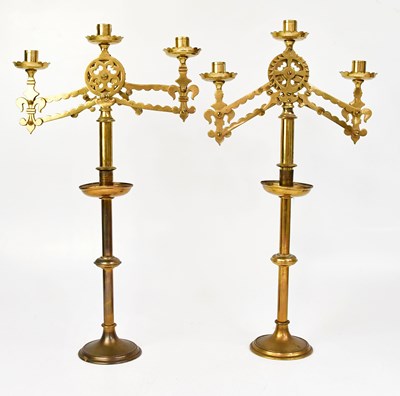 Lot 976 - A pair of brass ecclesiastical three-branch...