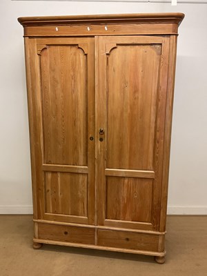 Lot 698 - A pine wardrobe, 210 x 125 x 54cm.