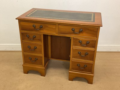 Lot 771 - A reproduction kneehole desk with leather...