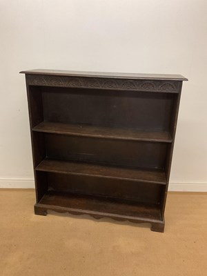 Lot 732 - An oak open bookcase with carved detail to top,...