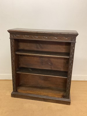 Lot 733 - An oak open bookcase with carved edges, 105 x...