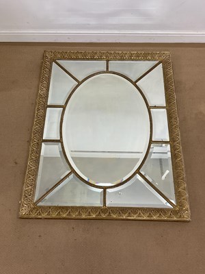 Lot 695 - A gilded bevel edged wall mirror with oval...