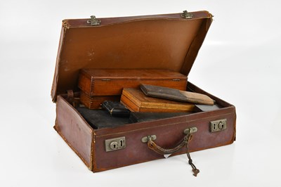 Lot 1447 - A leather suitcase containing a large...