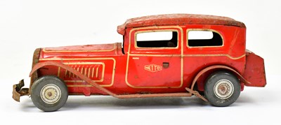 Lot 237 - A Mettoy tinplate clockwork saloon car in red...