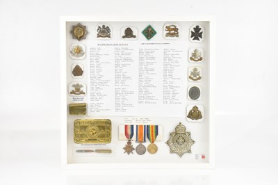 Lot 1240 - A framed montage containing three WWI medals,...
