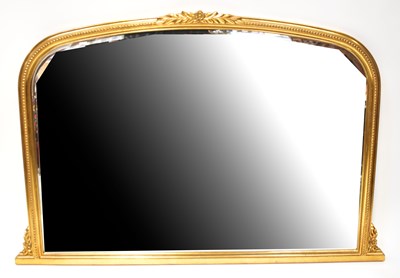 Lot 46 - A gilt overmantel mirror with arched top and...