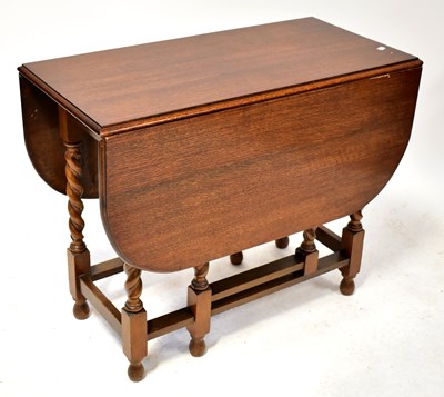 Lot 22 - A 1930s oak gateleg drop-leaf supper table, on...