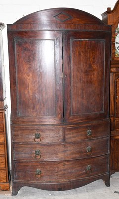 Lot 2732 - A Regency mahogany bowfront linen press, with...