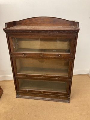 Lot 700 - THE LEBUS BOOKCASE; a three section oak...