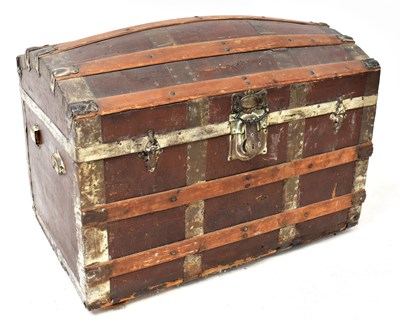 Lot 29 - A vintage leather-covered domed travel trunk...