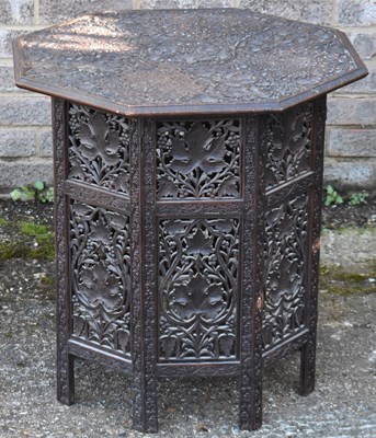 Lot 49 - A Moorish carved hardwood octagonal table on...