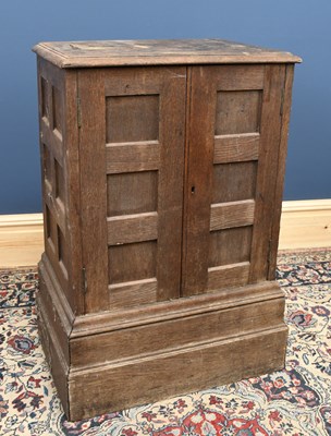 Lot 2851 - An oak two door cupboard on oversized plinth...