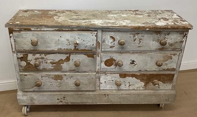 Lot 750 - A distressed pine chest of six drawers on...