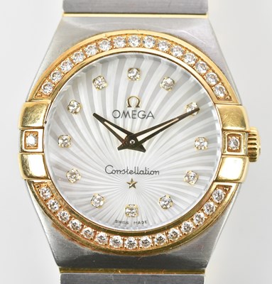 Lot 565 - OMEGA; a lady's bi-metal Constellation...
