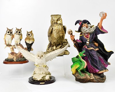 Lot 523 - A resin figure of a wizard holding a crystal,...