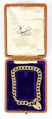 Lot 1409 - A 9ct yellow gold curb link padlock bracelet,...