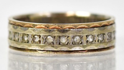 Lot 1324 - A 9ct yellow gold wedding band set with tiny...