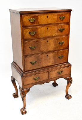 Lot 56 - A reproduction walnut crossbanded chest on...