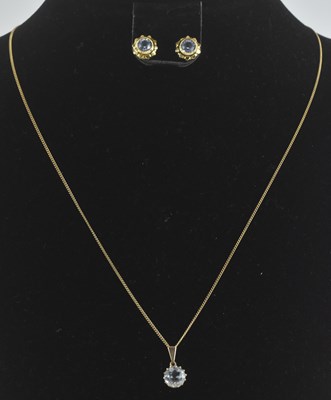 Lot 1390 - A 9ct yellow gold aquamarine set pendant, on...