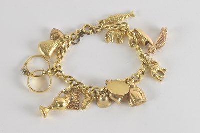 Lot 1498 - A 9ct gold charm bracelet, with sixteen...