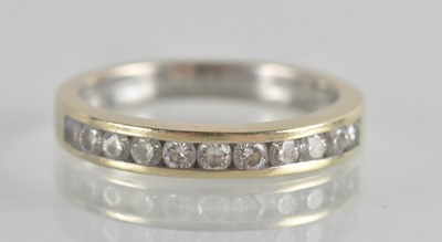 Lot 1324 - An 18ct gold ring set with eleven tiny channel...