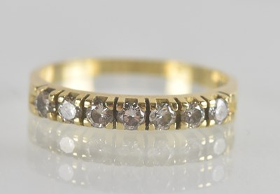 Lot 1325 - An 18ct gold ring set with seven small...