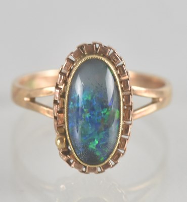 Lot 1360 - A 10C gold ring with an opal style bezel set...