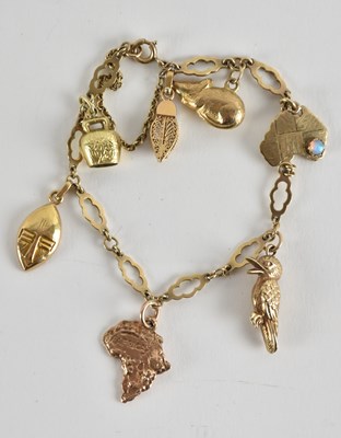 Lot 1503 - A 9ct gold charm bracelet, with seven charms...