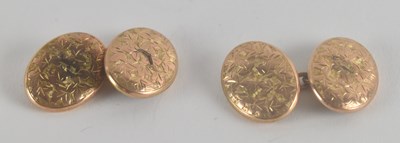 Lot 1465 - A pair of 9ct gold oval cufflinks with floral...