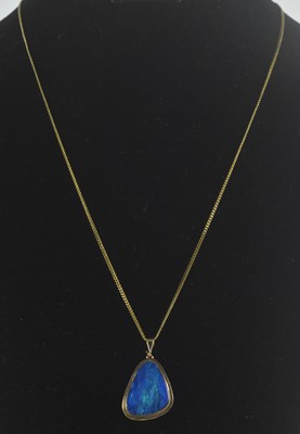 Lot 1367 - A triangular shaped bezel set opal of...