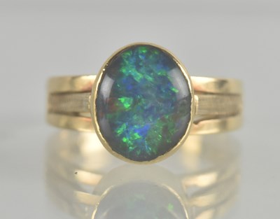 Lot 1237 - A 9ct gold opal set ring, the oval bezel set...