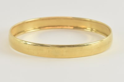 Lot 1516 - A yellow gold bangle, marks rubbed, diameter...