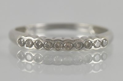 Lot 1329 - A 9ct white gold ring set with ten tiny...