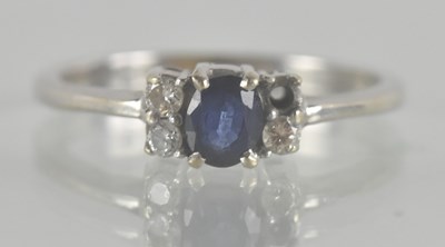Lot 1281 - An 18ct white gold diamond and sapphire set...