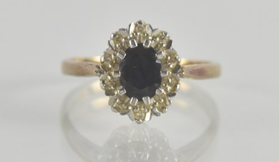 Lot 1359 - A 9ct gold sapphire and white stone cluster...