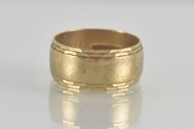 Lot 1283 - A 9ct gold band ring with outer rim decoration...