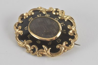 Lot 1484 - A 19th century mourning brooch with a central...