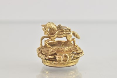 Lot 1386 - A 9ct gold seal/pendant, with a galloping...