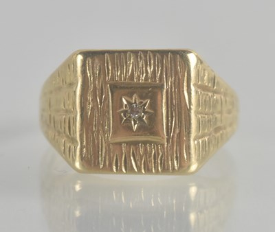 Lot 1337 - A 9ct gold signet ring, with textured table...