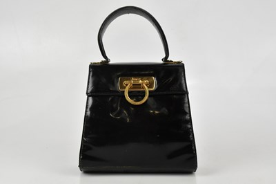 Lot 678 - SALVATORE FERRAGAMO; a small black patent...
