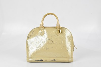 Lot 659 - LOUIS VUITTON; a cream patent leather 'Alma PM...